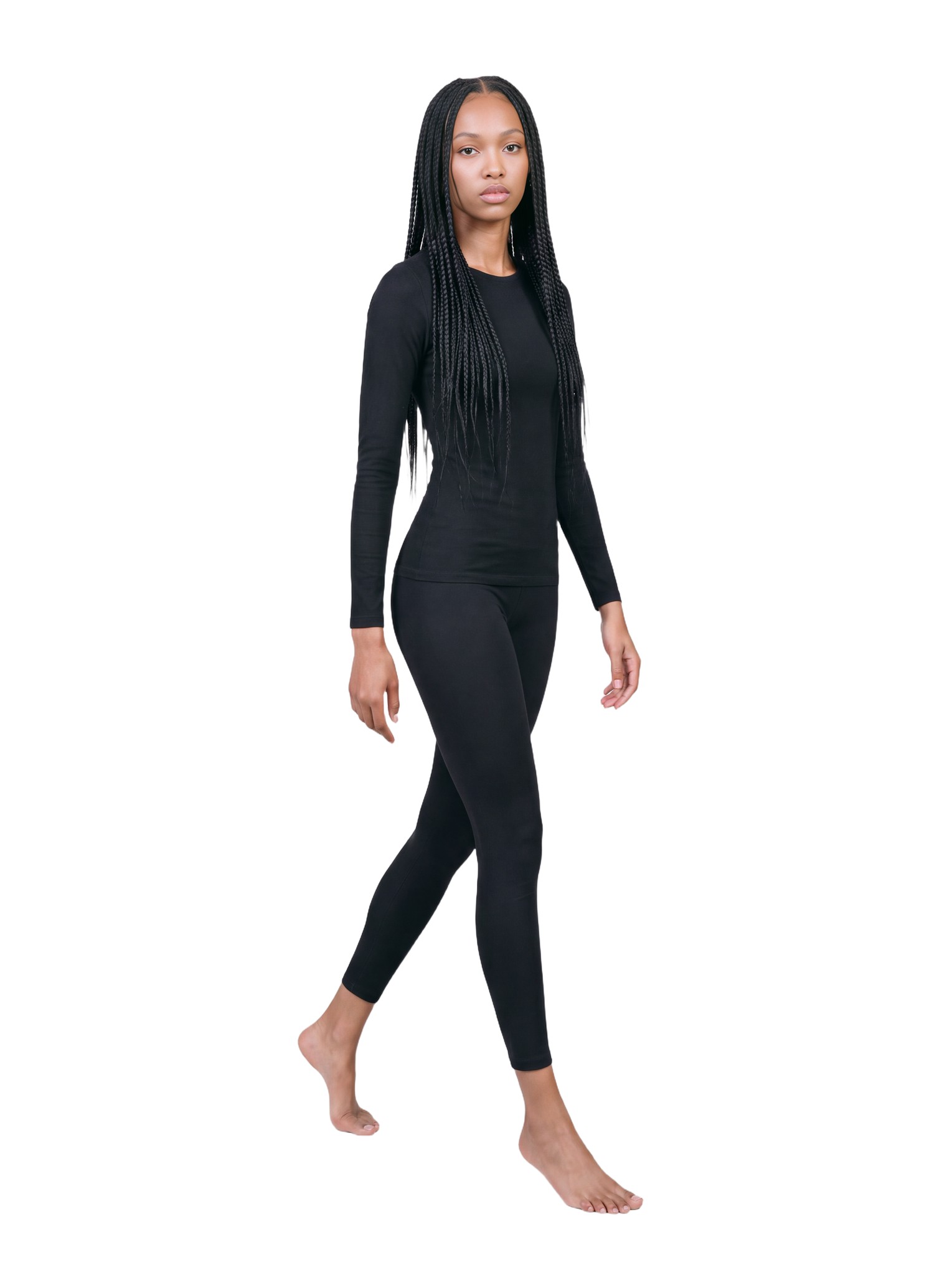 Amina walking toward the camera in the same black outfit